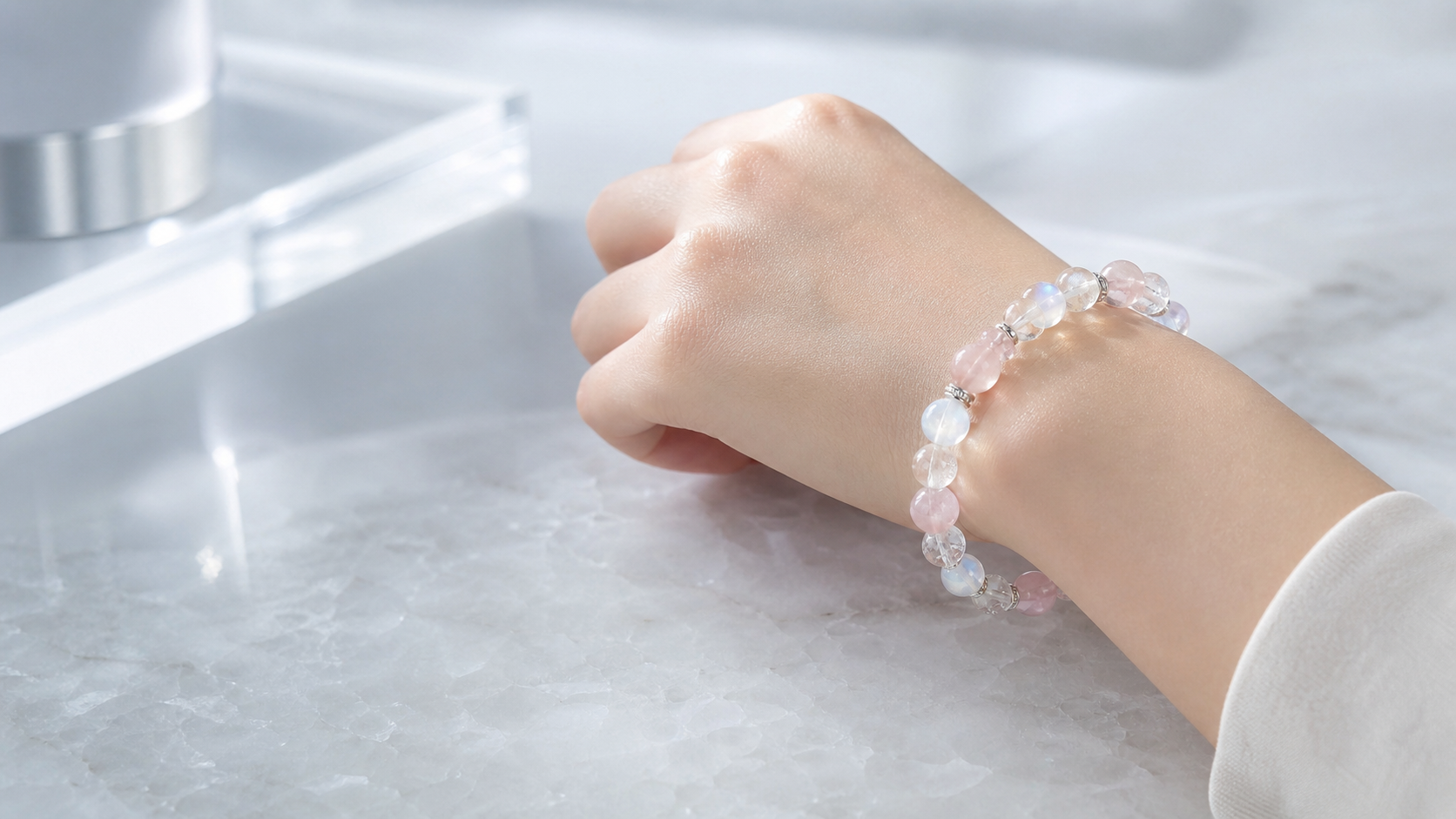 Wrist wearing a soft pink crystal bracelet in natural light